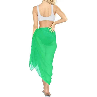 Woman wearing green chiffon beach skirt women beach wear from the back