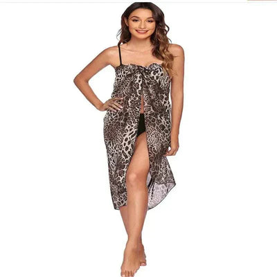 Woman wearing a sexy leopard print chiffon beach skirt with spaghetti straps and front slit, perfect beach skirt for women beachwear