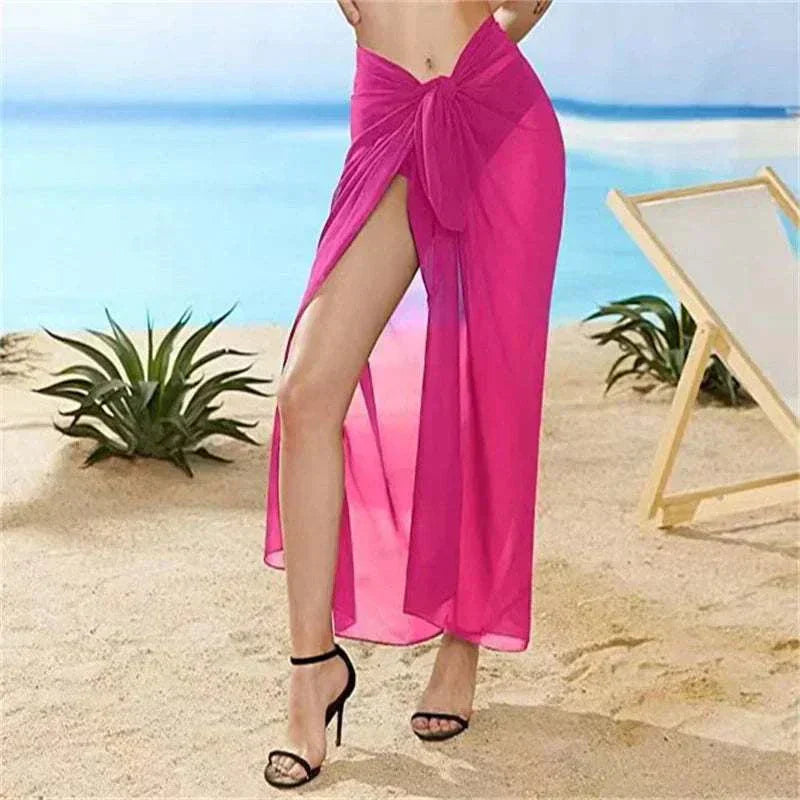 Women wearing sexy pink chiffon beach skirt with high slit at the beach
