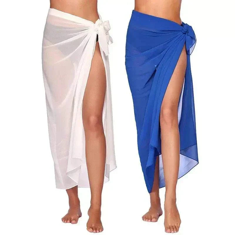 Two women wearing sexy chiffon beach skirts in white and blue, tied at the waist with side slits, showcasing beach skirt women style.