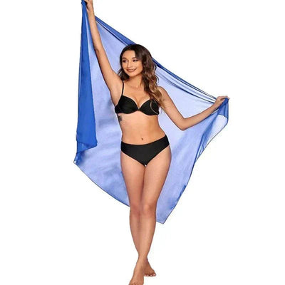 Woman wearing black bikini with sheer blue chiffon beach skirt women wrap on white background