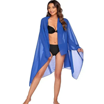 Woman wearing a sexy blue chiffon beach skirt and black bikini beachwear