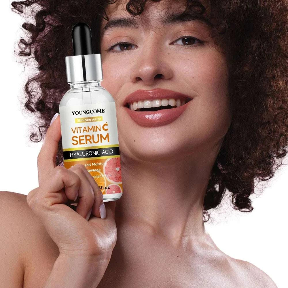 Young woman holding Vitamin C Facial Serum bottle with dropper for anti-aging and brightening skin care